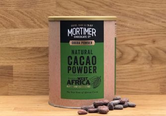 a lifestyle image of natural cacao powder with cocoa beans beside the product