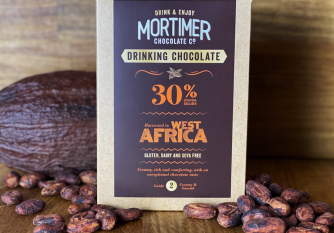 30% West African Drinking Chocolate as a lifestyle image surrounded by a cocoa pod and cocoa beans