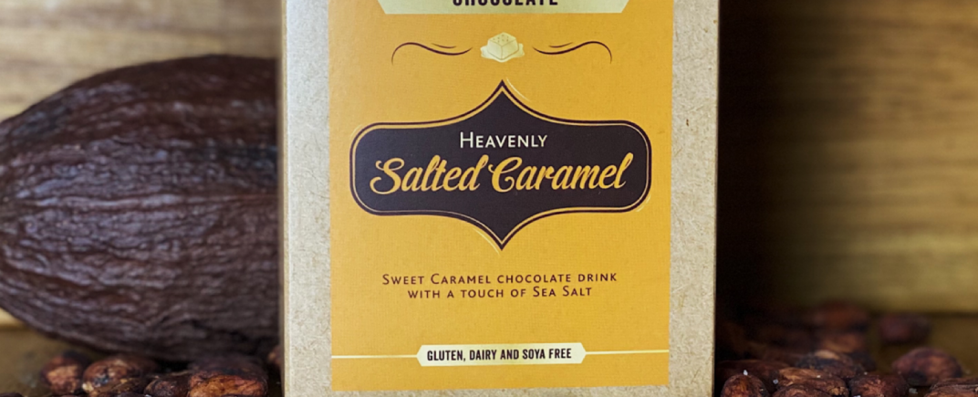 Salted Caramel Drinking Chocolate as a lifestyle image surrounded by salt, cocoa pods and cocoa beans