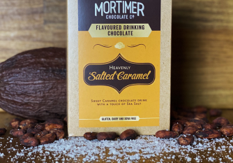 Salted Caramel Drinking Chocolate as a lifestyle image surrounded by salt, cocoa pods and cocoa beans