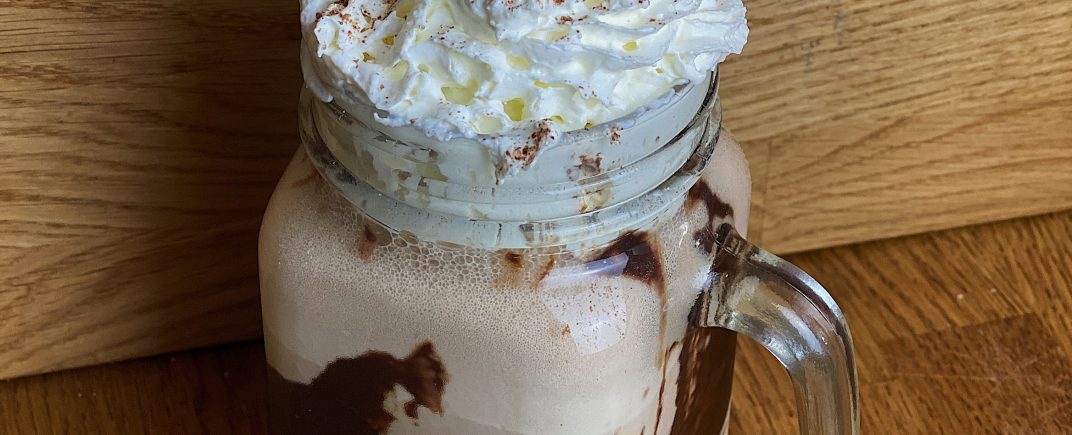 Salted Caramel Milkshake in a mason jar with whipped cream