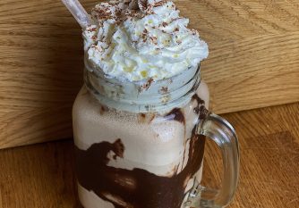 Salted Caramel Milkshake in a mason jar with whipped cream