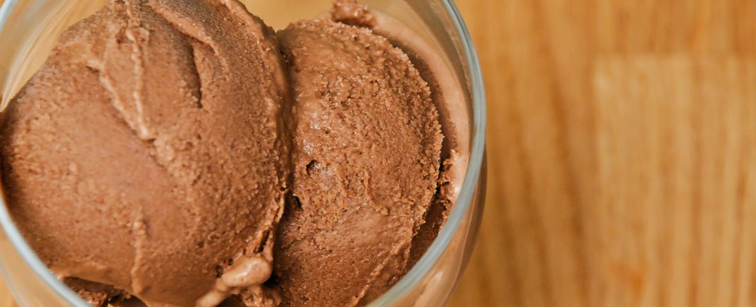 Salted Caramel Chocolate Ice cream scooped into a clear glass